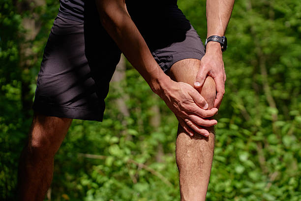 istock Man suffering from knee pain during running in park 2215857235