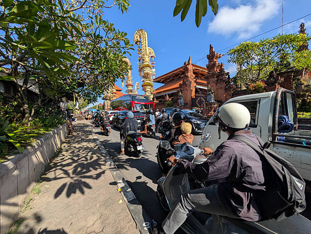 Denpasar, Indonesia - May 16, 2025: Rush hour at Kesiman street at Desa Adat Kesiman in Denpasar Bali