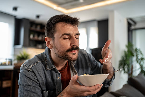istock Young man savoring delicious pasta at home 2215872592