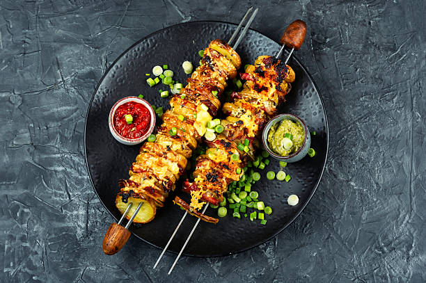 istock Potatoes with bacon on skewers, summer barbecue. 2215876996