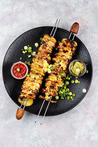 istock Skewers with fried young potatoes with bacon 2215877091