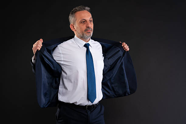 istock Businessman putting on his suit jacket 2215877724