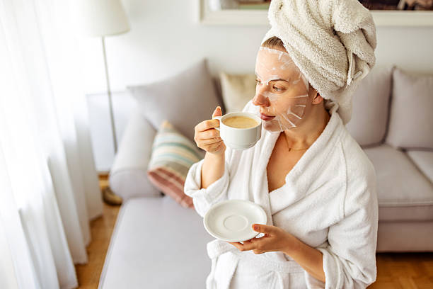 istock Relaxed Woman With Face Mask and Coffee in a Calm Interior Setting 2215878571