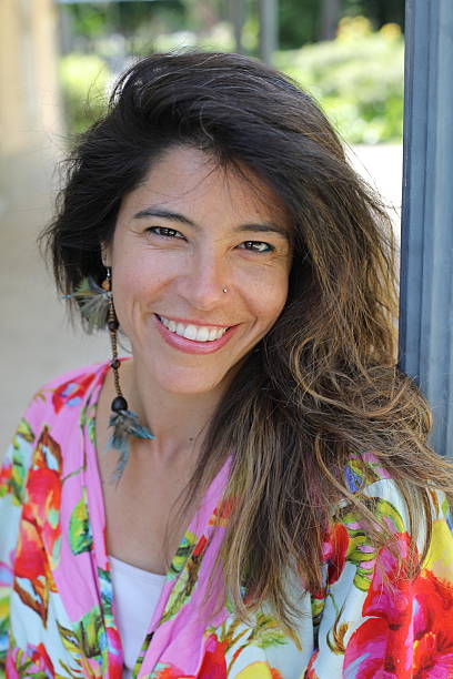 Beautiful Hispanic woman posing outdoors stock photo