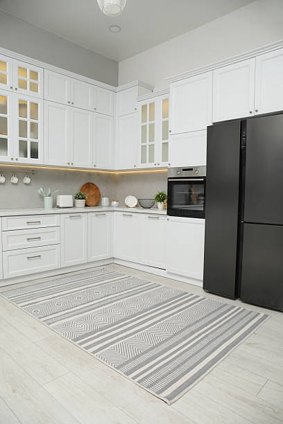 istock Beautiful rug on wooden floor in kitchen 2215886513
