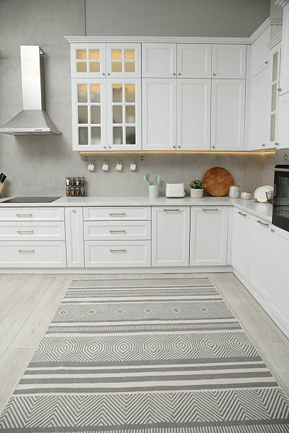 istock Beautiful rug on wooden floor in kitchen 2215886514