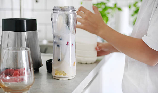 istock Little Girl Making A Milkshake And Shaking It With A Sport Shaker 2215895005