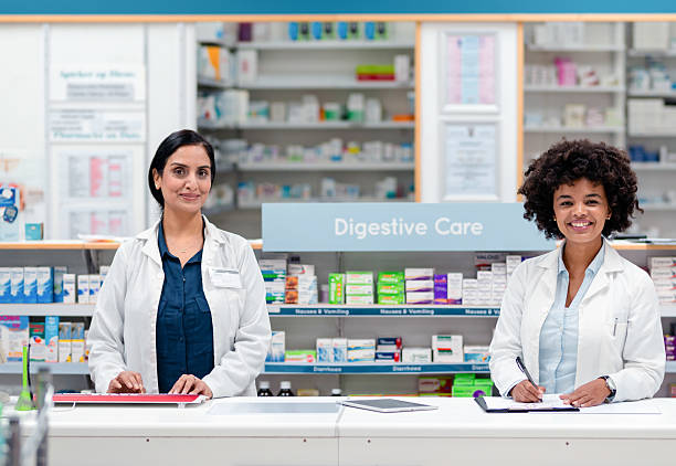 istock Friendly Pharmacists Working at a Modern Pharmacy Counter with a Professional and Welcoming Attitude 2215895378