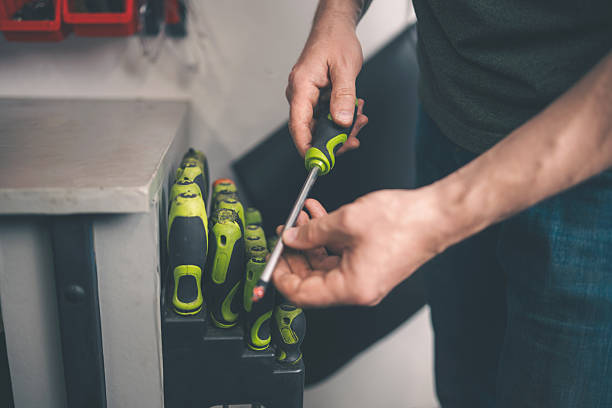 Man Choosing A Screwdriver In Screwdriver Set