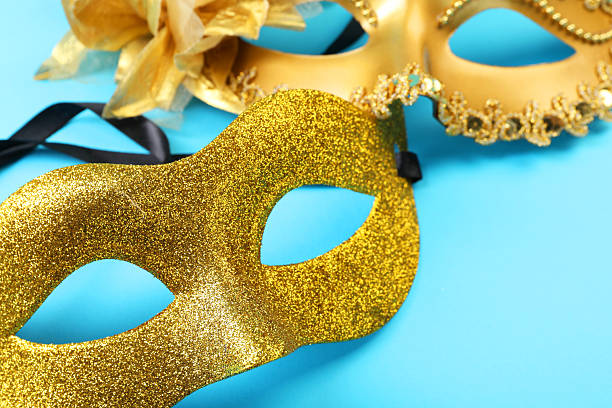 istock Beautiful carnival masks on light blue background, closeup 2215898351