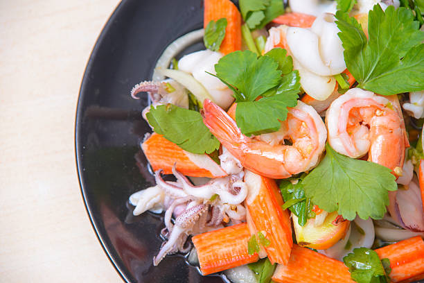 Boiled shrimps  on a dish against a white background