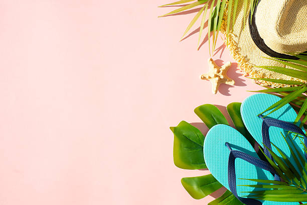 istock Summer vacation on pink with palm leaves and clothes. 2215901024