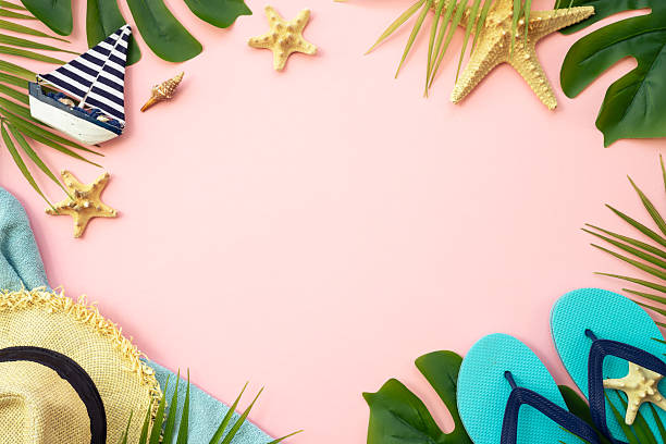 istock Summer vacation on pink with palm leaves and clothes. 2215901025