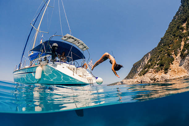 istock Beautiful woman jumping into sea 1/3 2215902099