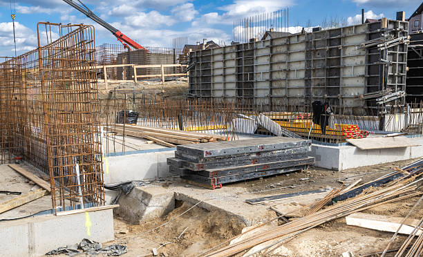 istock Construction Site With Foundation Work Underway in an Urban Area Surrounded by Machinery and Materials During a Clear Day 2215902163