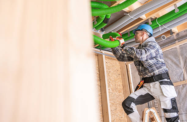 istock Skilled Construction Worker Installing Green Ventilation Pipes in a Residential Building During the Early Afternoon Hours of a Busy Workday 2215902539