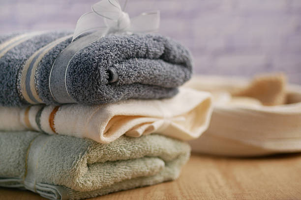 istock Soft towels stacked neatly on a wooden surface 2215902975