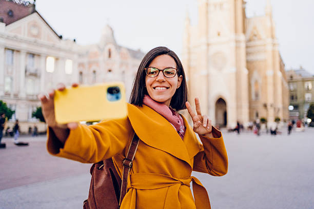 istock A young woman using phone in the city 2215906656