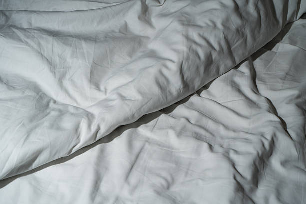 istock White silk fabric texture with soft folds and smooth surface background 2215907204