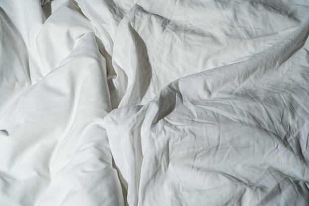 istock White silk fabric texture with soft folds and smooth surface background 2215907248