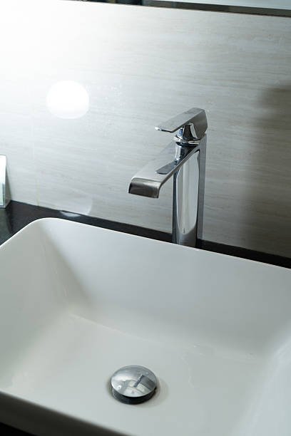 istock Shiny faucet in a clean bathroom sink 2215907575