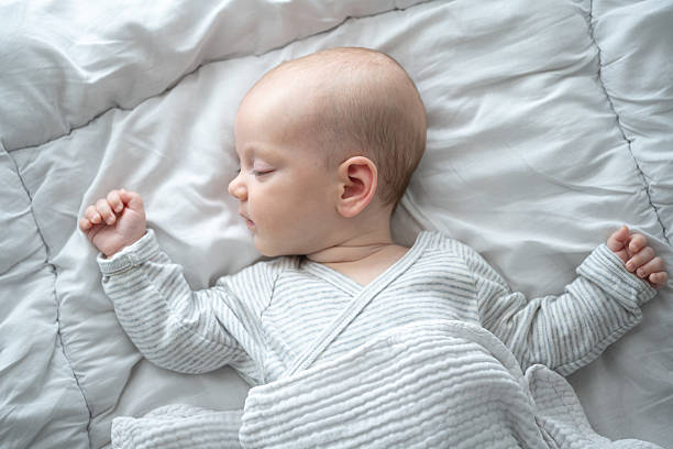 istock Sweet Dreams: A peaceful infant sleeps soundly, nestled gently within soft bedding, its serene face expressing innocence and tranquility. 2215907707