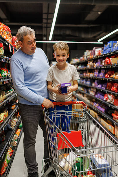 istock Father and Son Discussing Grocery Options 2215908537
