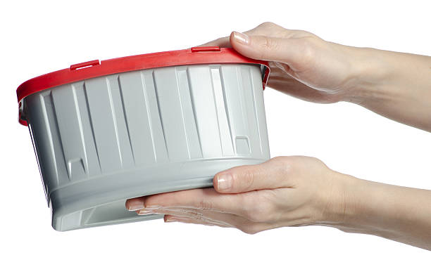 istock Hand holding container for washing laundry capsules 2215910025
