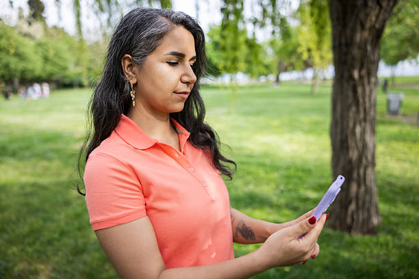 istock Iranian woman is typing message in nature. 2215913574