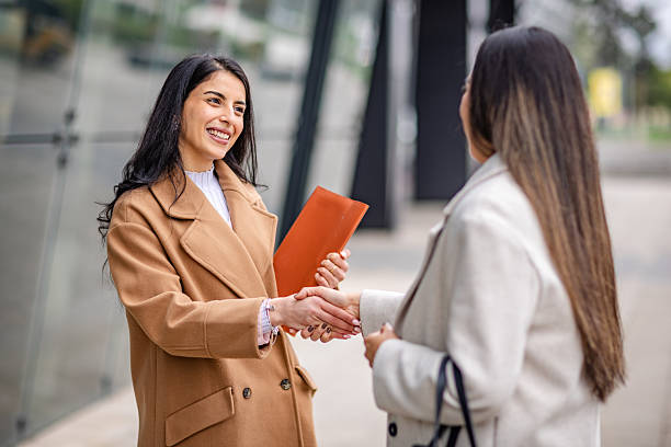 istock Businesswomen networking outdoors during a daytime meeting in a professional setting 2215914543