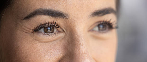 istock Cropped closeup smiling young female with dark eyes looking aside 2215915146