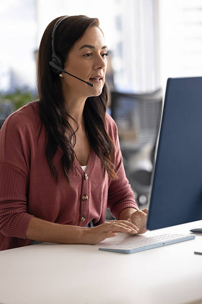 istock Busy millennial female in headset talking via video call 2215915259