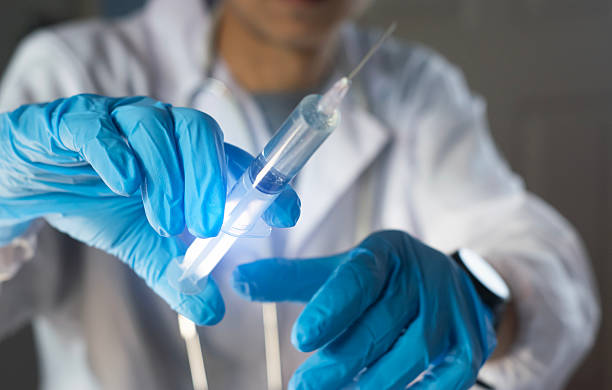 istock Doctors prepare syringes for vaccination 2215916837