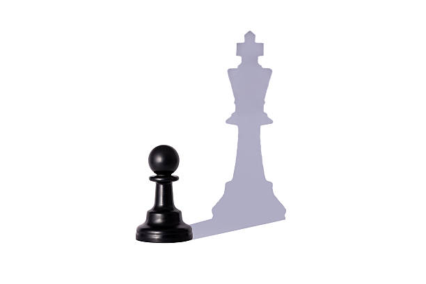 Aspiration. A picture of a pawn, but a shadow of a king chess piece.
