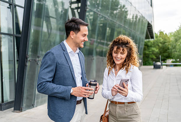 istock Young business colleagues using smartphone together outdoors 2215918468