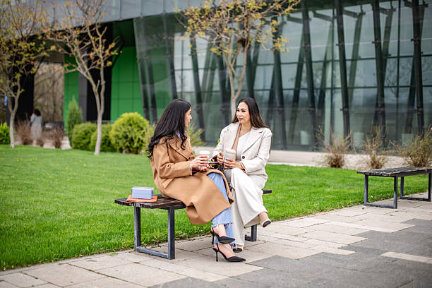 istock Two businesswomen engage in conversation outdoors, sharing insights in a professional setting during daytime 2215918637