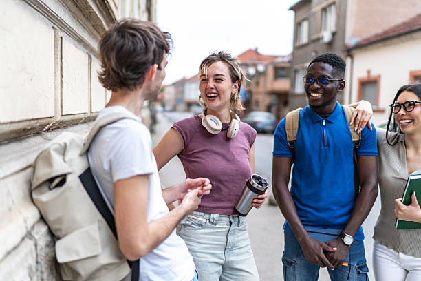istock Cheerful university students chatting together outdoors 2215919165