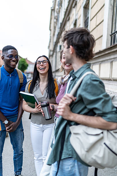 istock Cheerful university students laughing together outdoors 2215921138