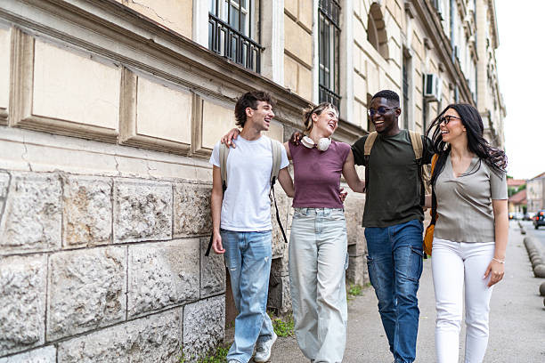 istock Cheerful students walking together on campus after class 2215921266