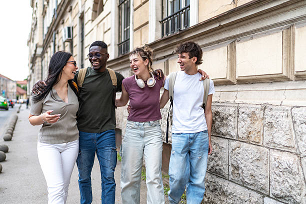 istock Diverse group of young adults walking together 2215921267