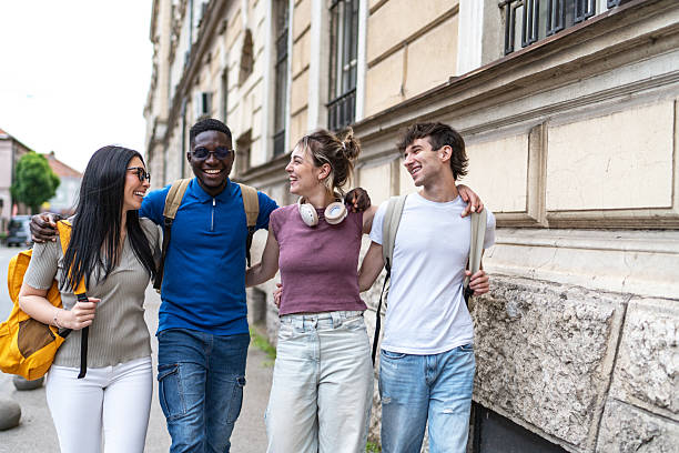 istock Happy students walking together in the city 2215921475