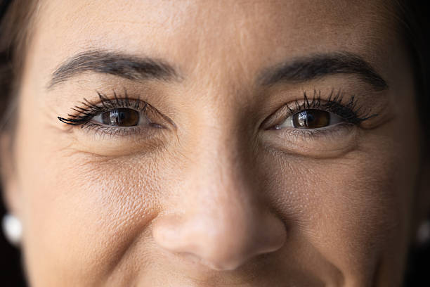 istock Upper part of face smiling young female looking at camera 2215921501