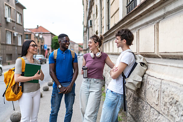 istock Cheerful university students chatting on campus street 2215921562