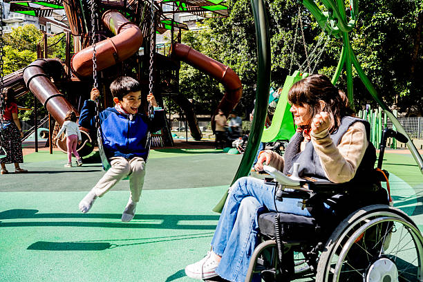istock Child boy with his mother swinging at outdoors playground 2215922295
