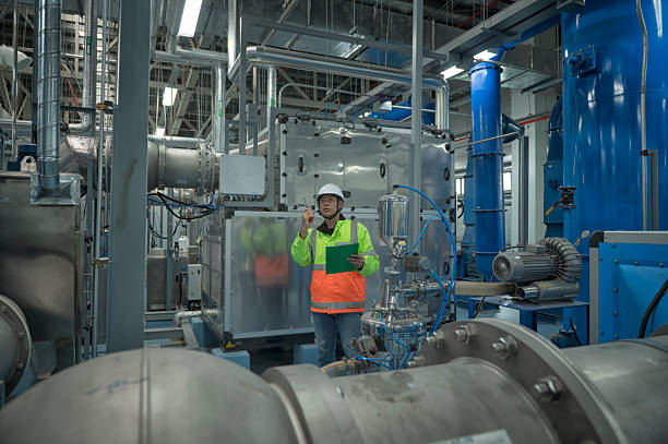 istock Asian Engineer Performing Pipe System Inspection in Modern Industrial Facility 2215926058