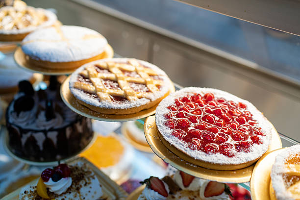 Freshly baked cakes and pies stacked in bakery aisle. Supermarket bakery section showcasing a variety of fresh desserts, including delicious cakes and pies, beautifully arranged.