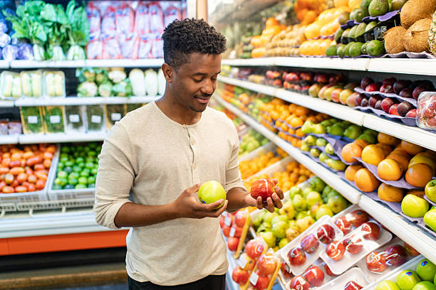 istock Man selecting apples in grocery store produce section 2215927908