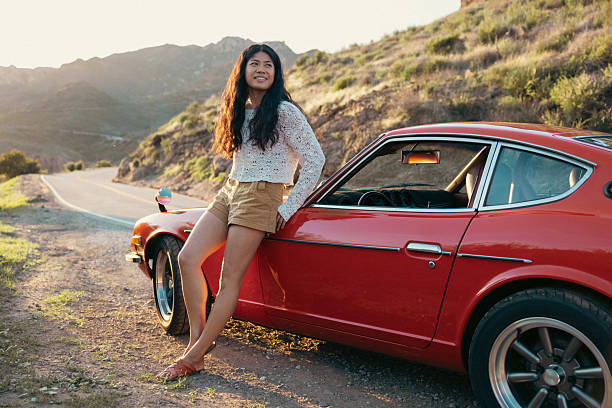 Shot of an empty vintage car parked along the coast at sunset