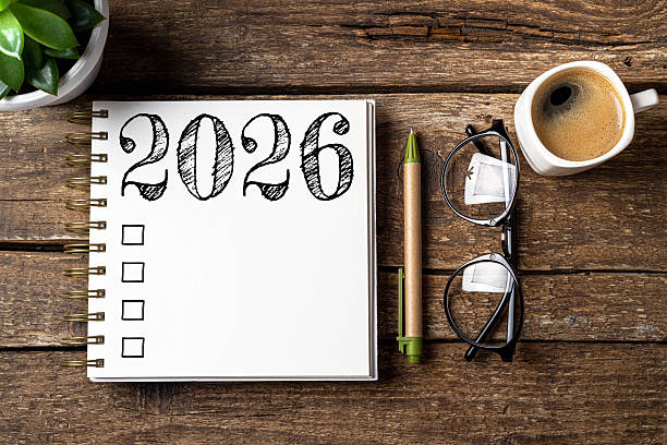 istock New year resolutions 2026 on desk. 2026 resolutions list with notebook, coffee cup on table. Goals, resolutions, plan, action, checklist concept. New Year 2026 template 2215930804
