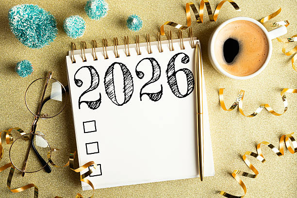 istock 2026 New year resolutions on desk. 2026 goals list with notebook, coffee cup, festive decorations on golden background. Resolutions, plan, goals, checklist, idea concept. New Year 2026 resolutions 2215930841